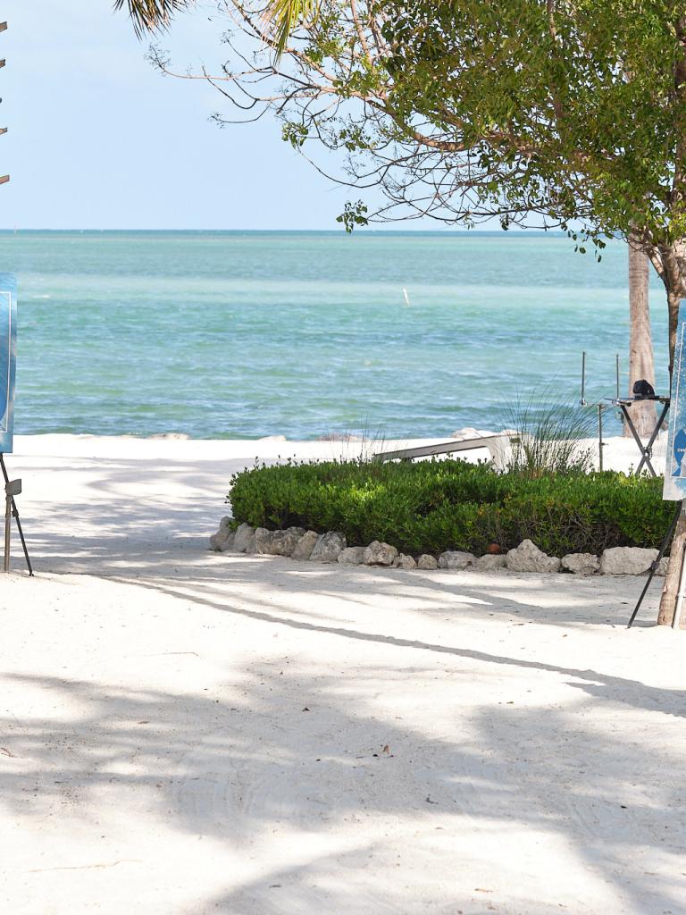 Posters of all the chefs from Helm to Hearth with the ocean in the background.