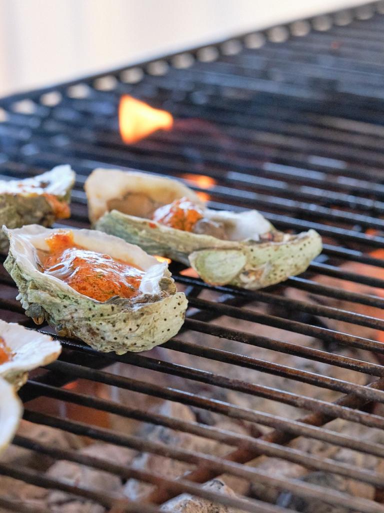 Oysters on a grill at Helm to Hearth.