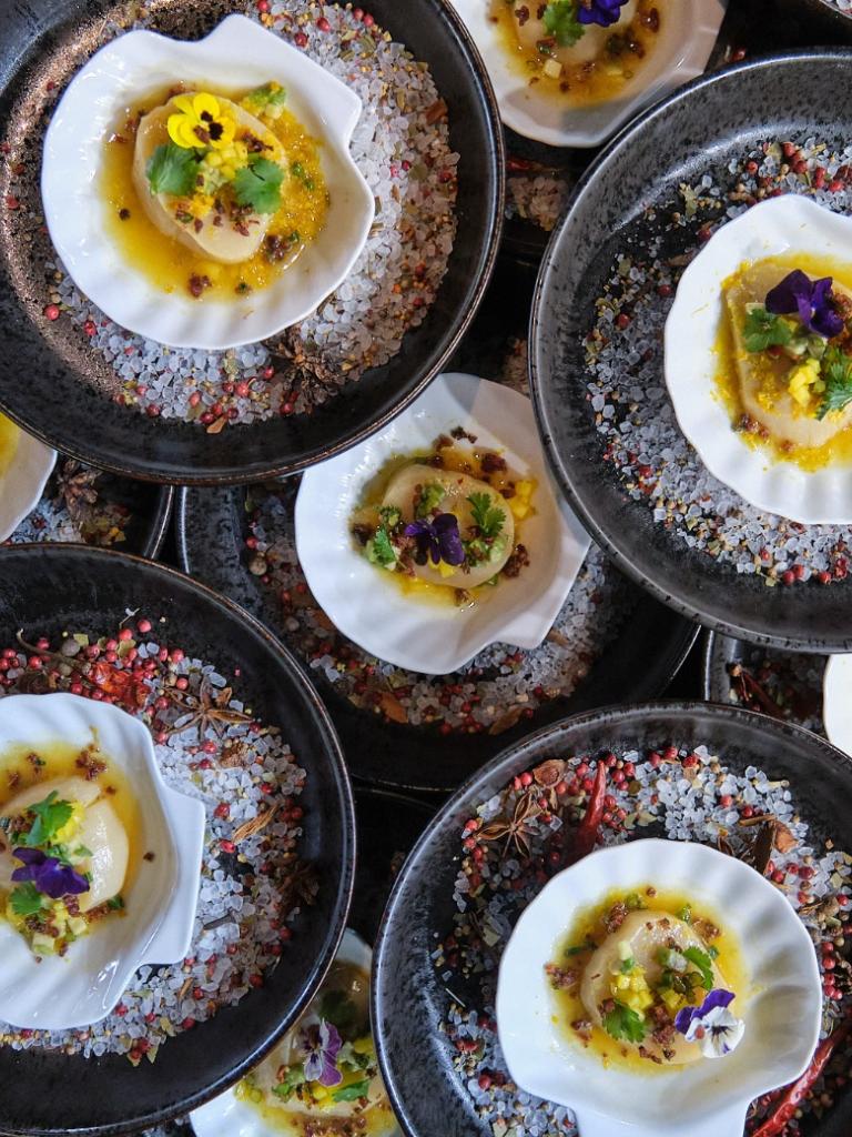 Scallops plated on seashells during Helm to Hearth.