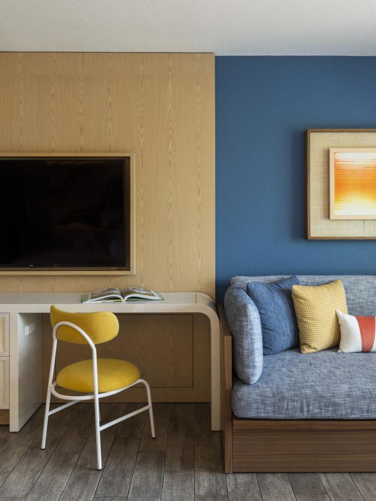 hotel room with a couch and workdesk at Three Waters Resort & Marina