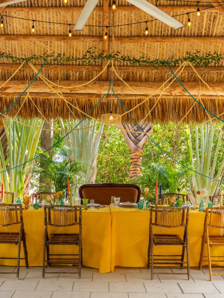 a meeting table decorated with colorful flowers and table cloth 