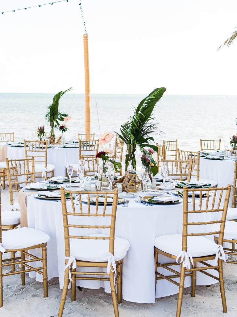 wedding table set up for a rehearsal dinner on the beach