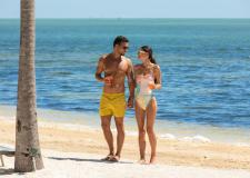A couple walking on the beach.