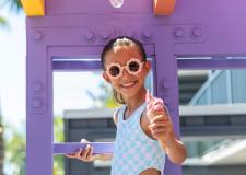 A girl smiling and eating ice cream.