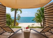 A lanai at La Siesta Resort & Villas. On the Lanai are two chairs with a table between them. 