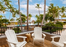 balcony with three adorondak chairs overlooking the resort