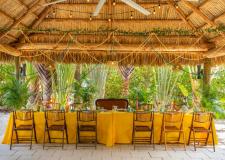 a meeting table decorated with colorful flowers and table cloth 