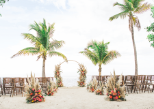 beach setting with wooden chairs and a wedding altar