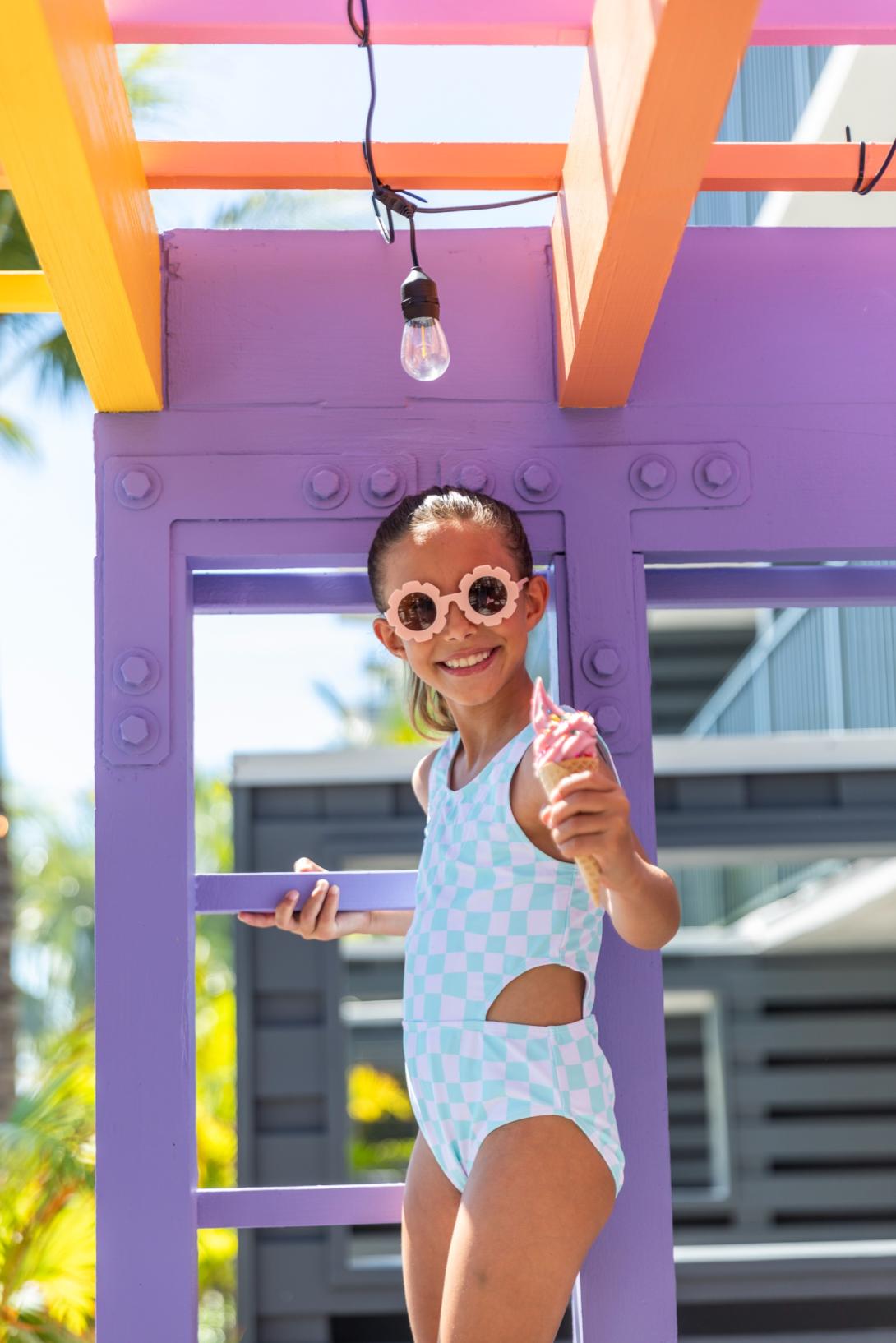 A girl smiling and eating ice cream.